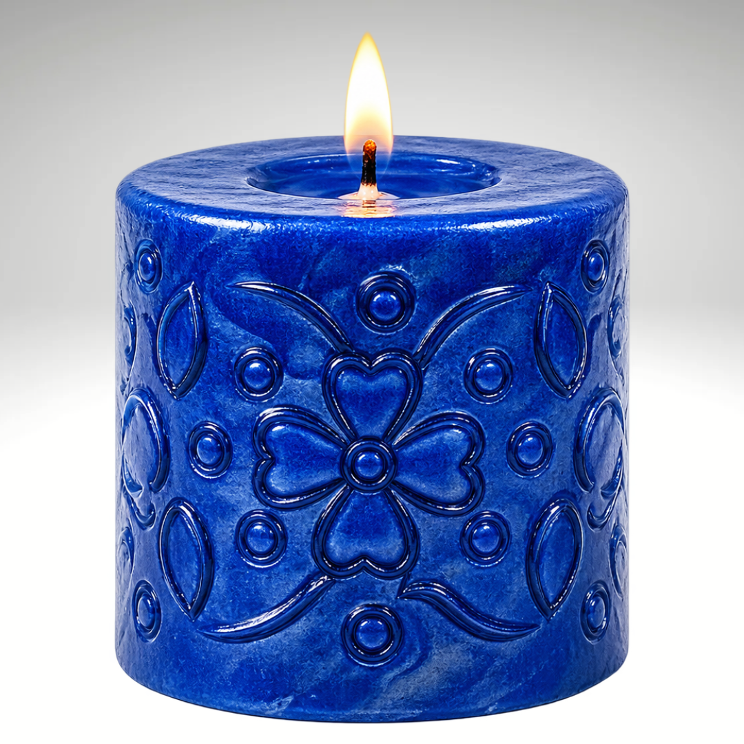 Blue pillar candle with intricate flower engraving, featuring an elegant decorative design for home décor and gifting.