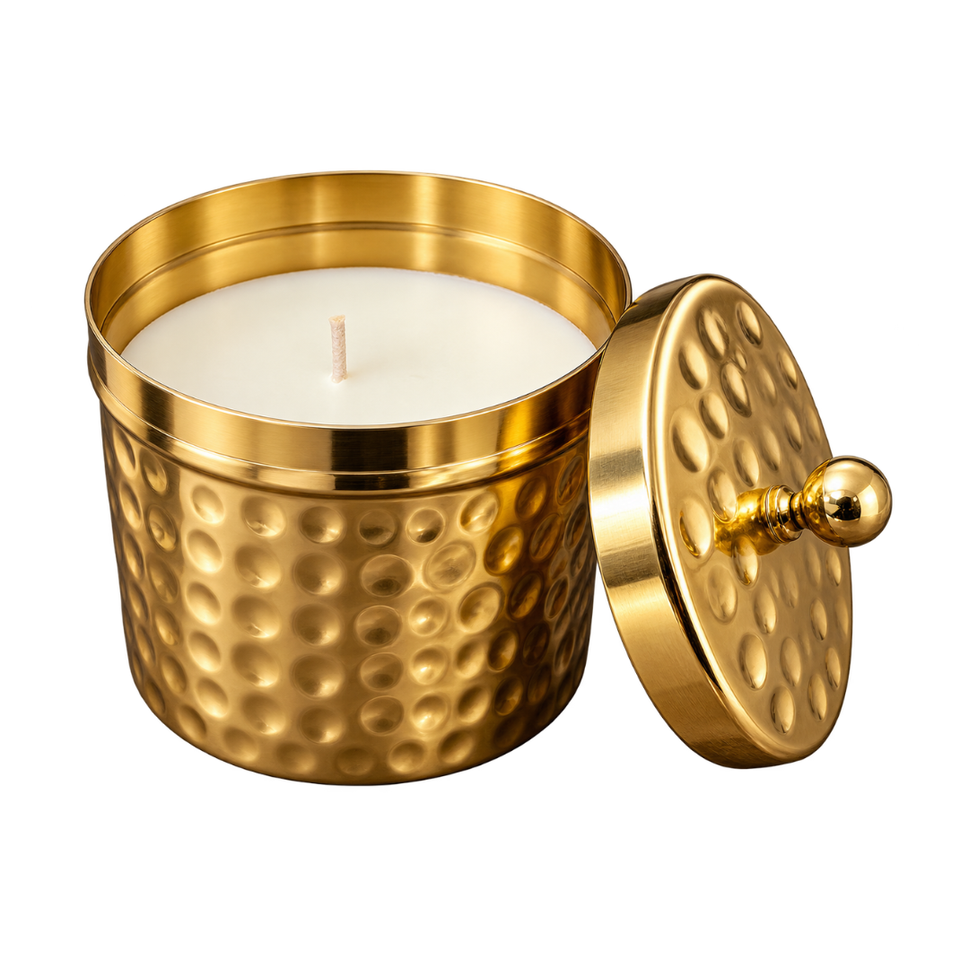 Hammered gold-finish metal candle jar with a white candle and matching decorative lid.
