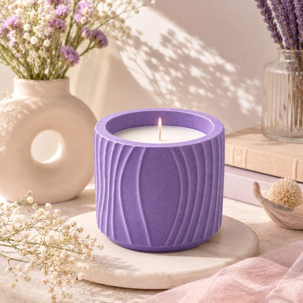 Lavender ribbed jar candle with white wax and a warm flame, styled with soft flowers, neutral décor, and gentle natural lighting.